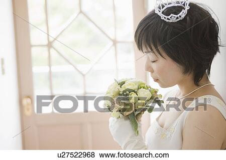 Stock Photo - Bride Smelling Bouquet of Flowers. Fotosearch
