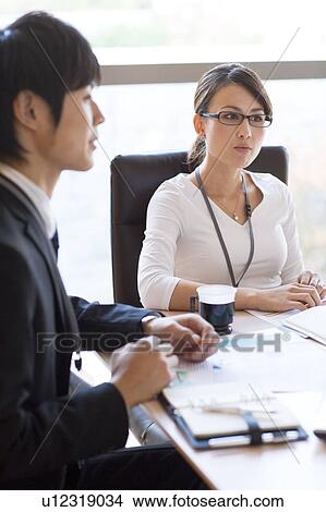 Picture - Business people having a meeting. Fotosearch