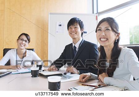 Stock Photo - Business people having a meeting. Fotosearch