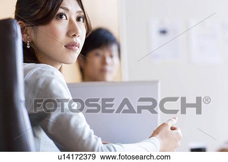 Stock Photo - Business people having a meeting. Fotosearch