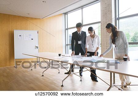 Business people looking at documents View Large Photo Image Stock Image - Business people looking at documents. Fotosearch