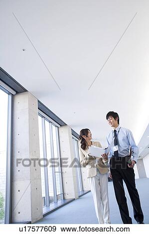 Business people looking at documents View Large Photo Image Stock Photo - Business people looking at documents. Fotosearch
