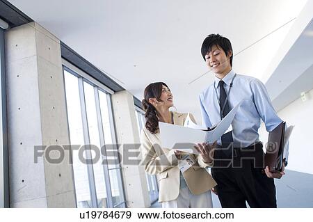 Business people looking at documents View Large Photo Image Stock Photo - Business people looking at documents. Fotosearch