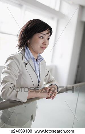 Businesswoman Leaning on Railing View Large Photo Image Stock Photo - Businesswoman Leaning on Railing. Fotosearch