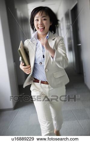 Stock Photo - Businesswoman Running in Corridor. Fotosearch