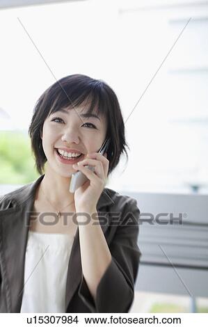 Businesswoman Using Mobile Phone View Large Photo Image Picture - Businesswoman Using Mobile Phone. Fotosearch