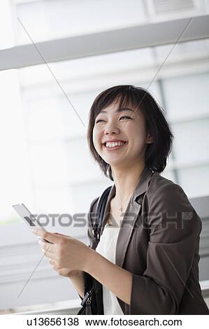 Stock Photo - Businesswoman Using Mobile Phone. Fotosearch