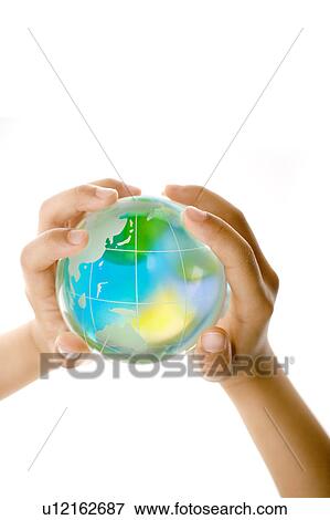 Stock Photo - Child holding a glass globe. Fotosearch