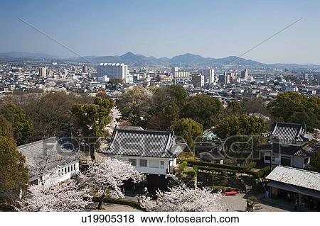 Stock Photo - Cityscape and Mountains in the Background. Fotosearch