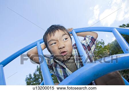 Stock Photography - Close-up of a boy making a face, Japan. Fotosearch