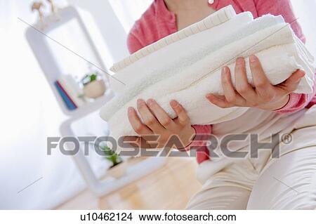 Picture - Close up of Woman Folded Towels. Fotosearch