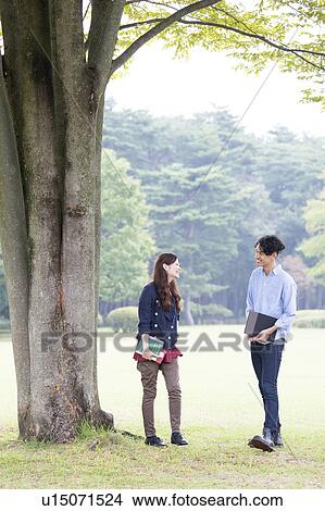 College students talking under the tree View Large Photo Image Picture - College students talking under the tree. Fotosearch