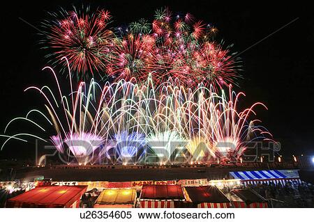 Stock Photography - Colorful Fireworks Over the Food Stalls. Fotosearch