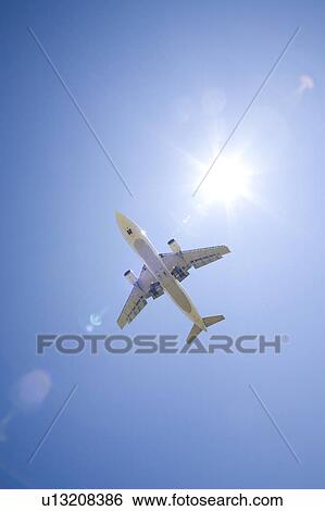 Commercial airplane, low angle view View Large Photo Image Stock Photograph - Commercial airplane, low angle view. Fotosearch
