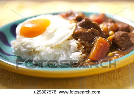 Stock Photograph - Curry with fried egg. Fotosearch