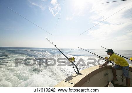 Stock Image - Fisherman on boat, Tokyo prefecture, Japan. Fotosearch