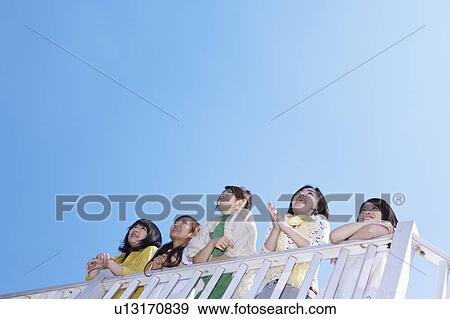 Stock Photo - Five Young Women Against Clear Sky. Fotosearch