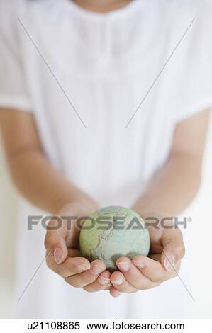 Stock Photography - Girl Holding Globe in her Hands. Fotosearch