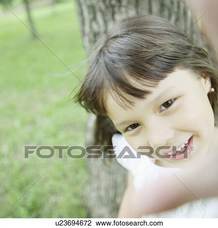 Stock Image - Girl Holding Hand Near Camera Lens. Fotosearch