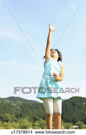 Girl Reaching for Soap Bubbles View Large Photo Image Picture - Girl Reaching for Soap Bubbles. Fotosearch
