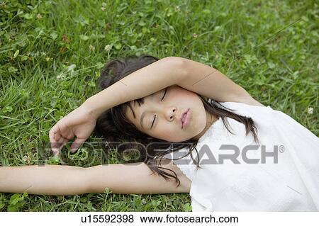 Girl Sleeping on Grass View Large Photo Image Stock Photo - Girl Sleeping on Grass. Fotosearch