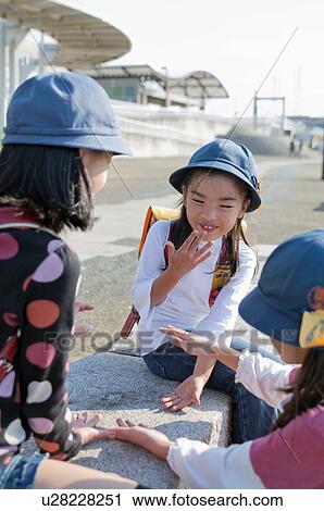 Stock Image - Girls talking, Japan. Fotosearch