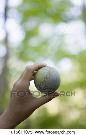 Stock Photography - Hand Holding Wooden Globe. Fotosearch