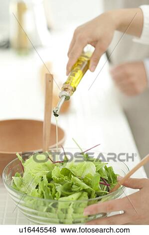 Stock Photo - Hand making salad . Fotosearch