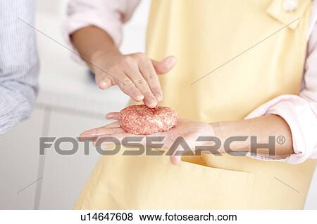 Stock Photo - Hands making hamburger stake. Fotosearch