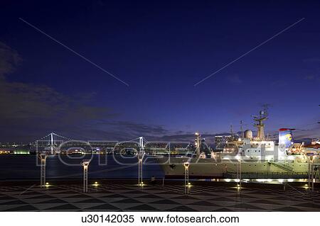 Stock Photography - Harumi Terminal Port and Rainbow Bridge at dusk, Chuo Ward, Tokyo Prefecture, Honshu, Japan. Fotosearch