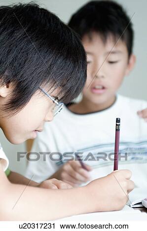 Stock Image - Kids doing homework, Japan. Fotosearch