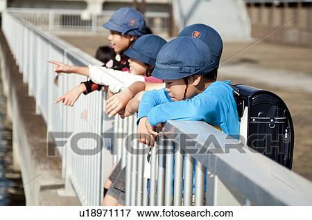 Kids looking at river together, Japan View Large Photo Image Stock Photo - Kids looking at river together, Japan. Fotosearch