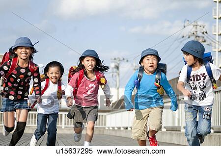 Stock Photography - Kids running home from elementary school, Japan. Fotosearch