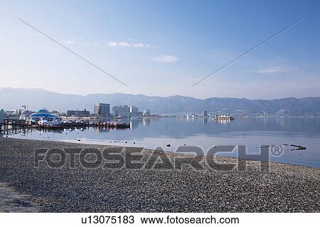 Stock Image - Lake Suwa and Cityscape of Suwa city, Nagano Prefecture, Honshu, Japan. Fotosearch