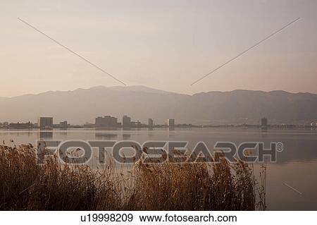 Stock Photo - Lake Suwa at dawn, Nagano Prefecture, Honshu, Japan. Fotosearch