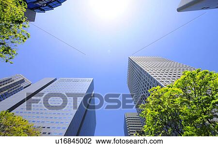 Stock Image - Low angle of Tall Building and Blue Sky. Fotosearch