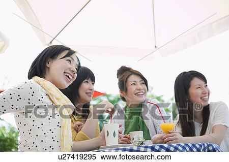 Low Angle View of Four Female Friends at Cafe View Large Photo Image Stock Photography - Low Angle View of Four Female Friends at Cafe. Fotosearch