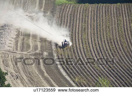 Stock Photo - Man on a tractor, Hokkaido Prefecture, Japan. Fotosearch