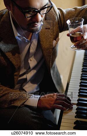 Mature Man Having a Drink and Playing Piano View Large Photo Image Stock Image - Mature Man Having a Drink and Playing Piano. Fotosearch