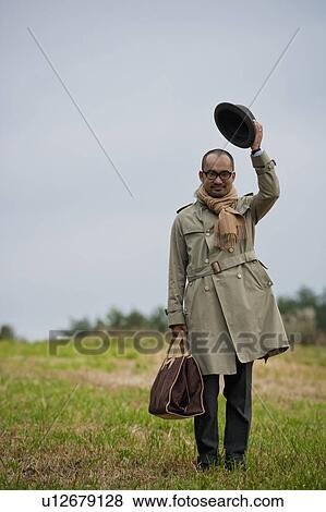 Mature Man Standing in Grass and Tipping Hat View Large Photo Image Stock Photo - Mature Man Standing in Grass and Tipping Hat. Fotosearch