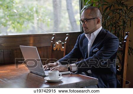 Mature Man Using Laptop on Table View Large Photo Image Stock Photography - Mature Man Using Laptop on Table. Fotosearch