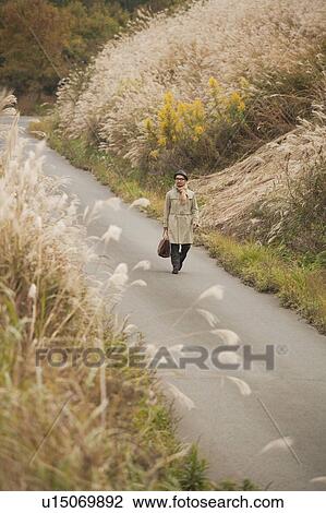 Mature Man Walking on Rural Road View Large Photo Image Stock Image - Mature Man Walking on Rural Road. Fotosearch