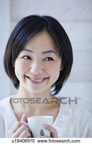 Stock Image - Mid Adult Woman Drinking Coffee. Fotosearch