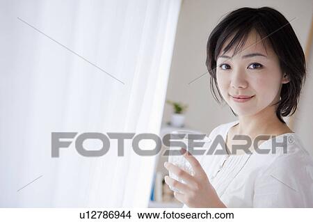 Mid Adult Woman Having Water by Window View Large Photo Image Picture - Mid Adult Woman Having Water by Window. Fotosearch