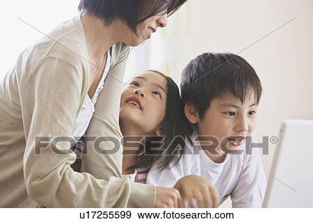 Mother and children using laptop View Large Photo Image Stock Photo - Mother and children using laptop. Fotosearch
