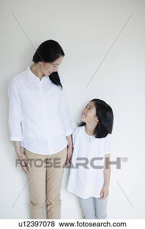 Stock Photo - Mother and Daughter Looking at Each Other. Fotosearch