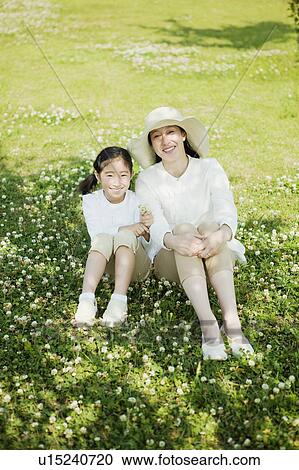 Mother and Daughter Sitting on Grass View Large Photo Image Stock Image - Mother and Daughter Sitting on Grass. Fotosearch