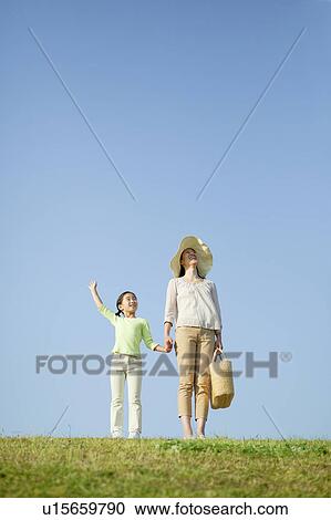Mother and Daughter Standing in Field and Looking up View Large Photo Image Stock Image - Mother and Daughter Standing in Field and Looking up. Fotosearch