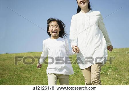 Mother and Daughter Walking in Field View Large Photo Image Stock Photo - Mother and Daughter Walking in Field. Fotosearch