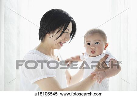 Stock Photography - Mother Holding Baby Boy. Fotosearch